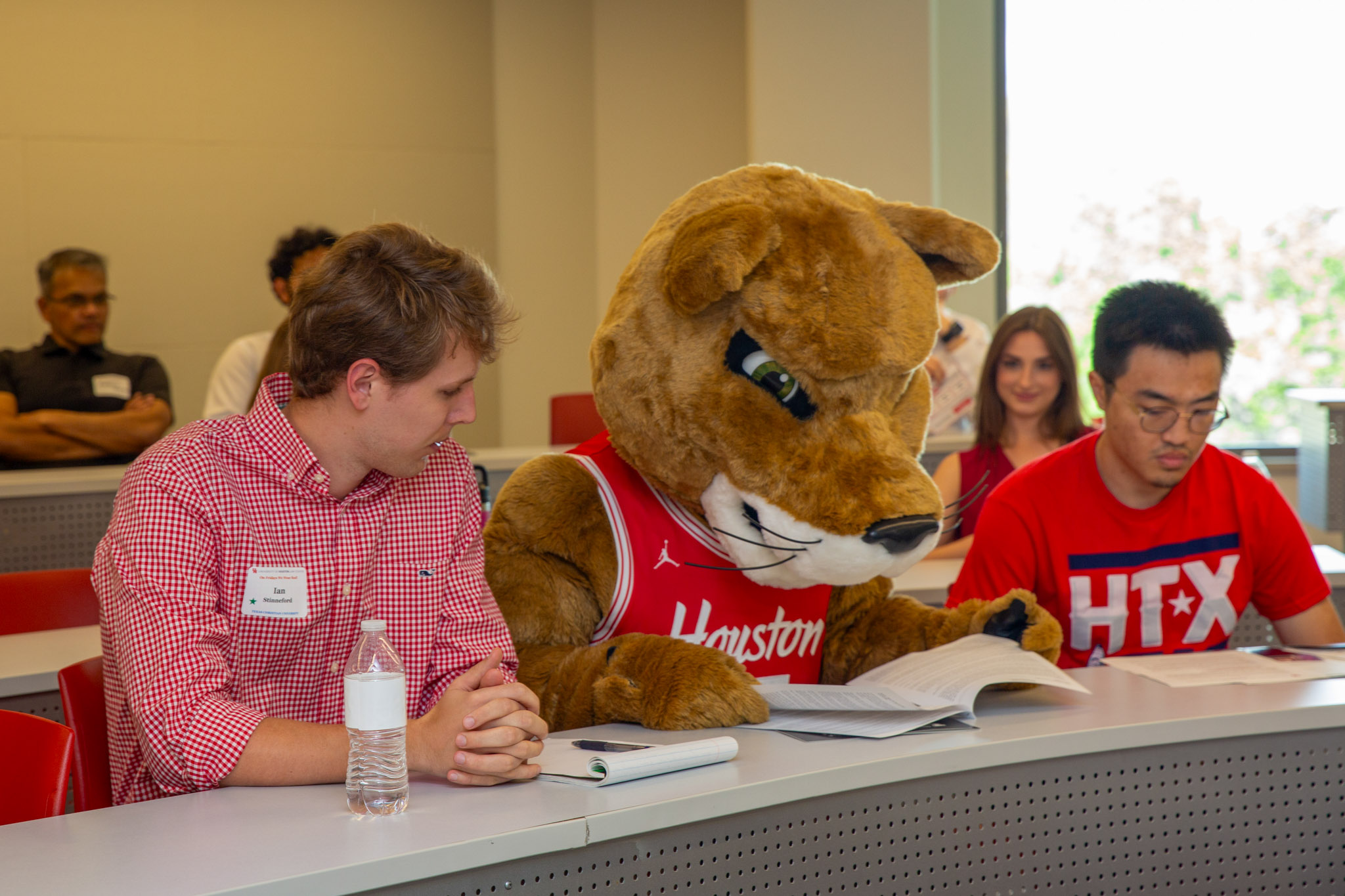 Shasta reviews the day’s agenda with prospective students seated in a classroom at the University of Houston Law Center.